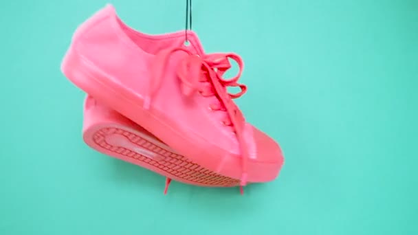 Hanging Bright Colored Sneakers. Fashion Woman Trendy Trainers. Stylish Hipster Plimsole Bright Pink Turquoise Color Sneakers. Minimal Pop Art Concept . Psychedelic Flat Lay. Art Design Background - Footage, Video