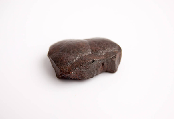 Piedra de hematita, superficie de piedra con capas de hematita y capas de cuarzo. Mineral de hierro aislado sobre fondo blanco
. - Foto, imagen