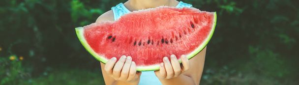 A child eats watermelon. Selective focus. food. - Fotografie, Obrázek