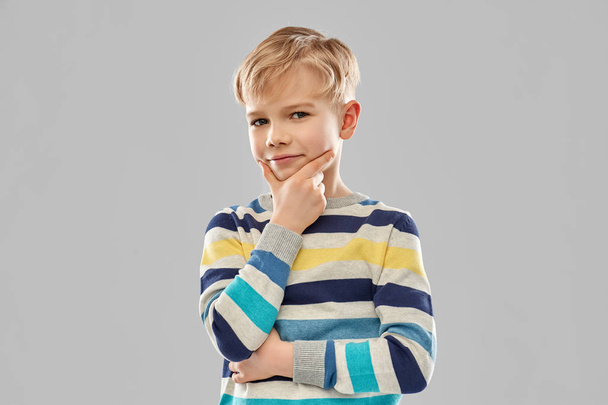 portrait of thinking boy in striped pullover - Φωτογραφία, εικόνα