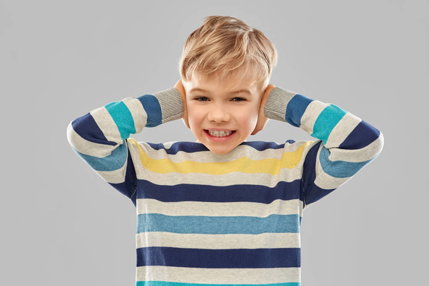 stressed boy in pullover closing ears by hands - Photo, Image