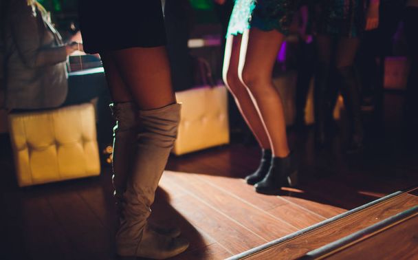 Legs of dancing people at the party. - Foto, Bild