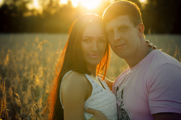 portrait beautiful couple man and woman on sunset background in summer - Photo, Image