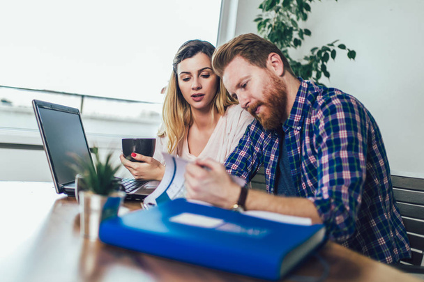 Woman and man doing paperwork together, they report online tax o - Photo, Image