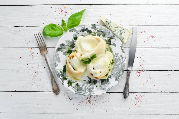 Pancakes with blue cheese, brie cheese and parmesan cheese. On a wooden background. Top view. Free space for your text. - Photo, image