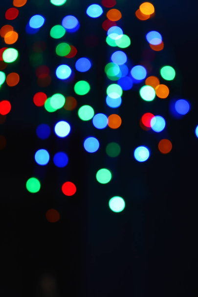 Colored lights (garland) in the dark. Bokeh effect Festive illumination. - Fotó, kép