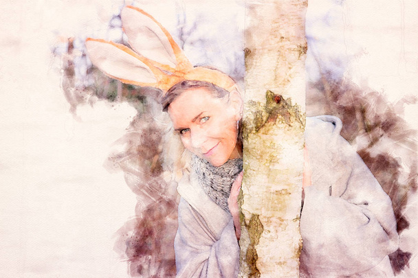beautiful blond woman in the park with bunny ears - Valokuva, kuva