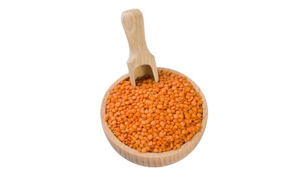 red lentils in wooden bowl and scoop isolated on white background. nutrition. bio. natural food ingredient. - Photo, Image