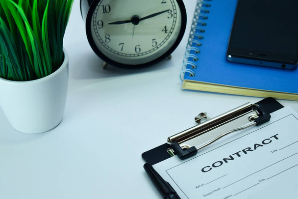 Planificación de contratos sobre antecedentes de mesa de trabajo con suministros de oficina. Planificación de Conceptos de Negocios y Horarios en White Desk
 - Foto, Imagen