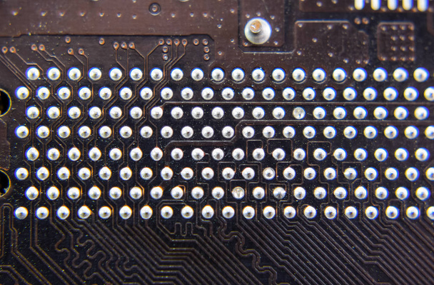 The reverse side of the microboard. Contacts solder. Soldered parts. Electronic board with electrical components. Electronics of computer equipment - Photo, image