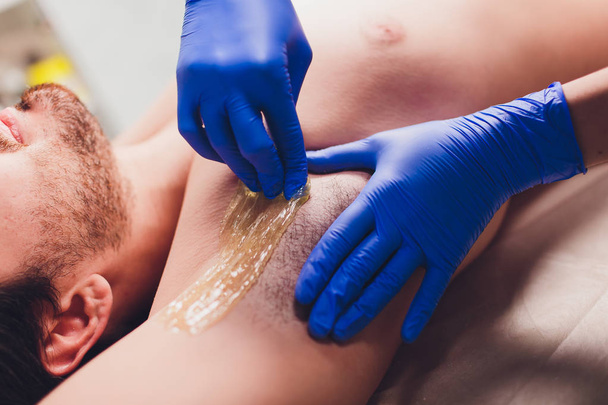 men sugaring hair removal armpit salon male. - Φωτογραφία, εικόνα