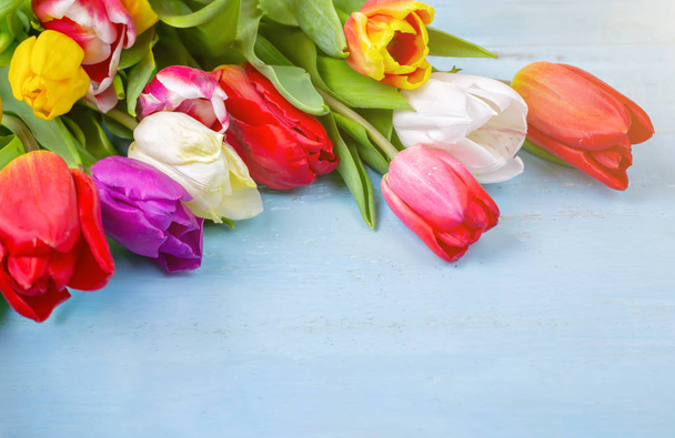 Bouquet of tulips on blue wooden table. Happy womens day. 8 March., Mothers Day. Flat lay and copy space - Foto, Bild