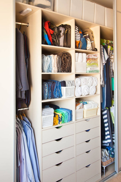 Clothing lying in the drawer in the wardrobe. T-shirts for women - 写真・画像