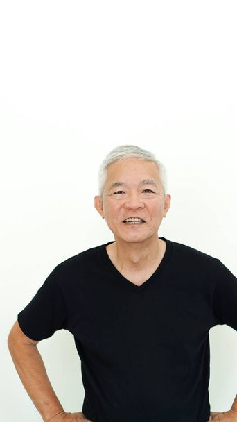 Handsome Asian senior man presenting white copy space - Foto, afbeelding