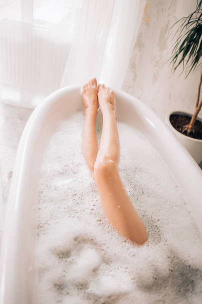 Beautiful sexy woman in bubble bathtub - 写真・画像