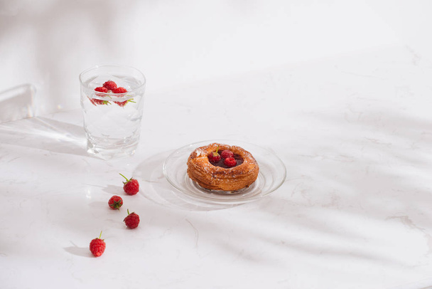 Sweet summer dessert, homemade puff pastry with berries , served with cold raspberry cider, fresh raspberries. On a white marble table, copy space top view  - Φωτογραφία, εικόνα