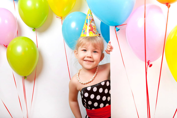 Portrait of a beautiful girl with a smile and balloons on white background - Foto, immagini