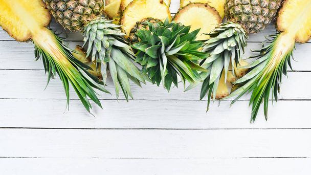 Pineapple on a white wooden background. Tropical Fruits. Top view. Free copy space. - Fotoğraf, Görsel