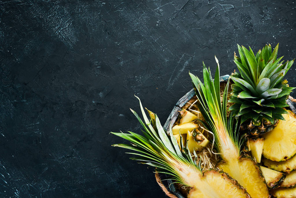 Pineapple in a wooden box. Tropical Fruits. Top view. Free copy space. - Foto, immagini
