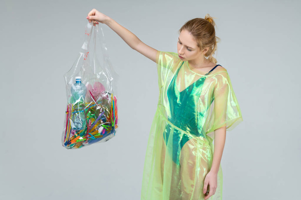 Blonde woman feeling upset while looking at too many plastic - Foto, immagini