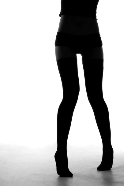 Silhouette of legs of young woman - Φωτογραφία, εικόνα