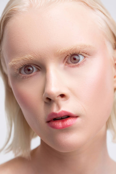Grey-eyed woman with white skin having strange face expression - Photo, Image