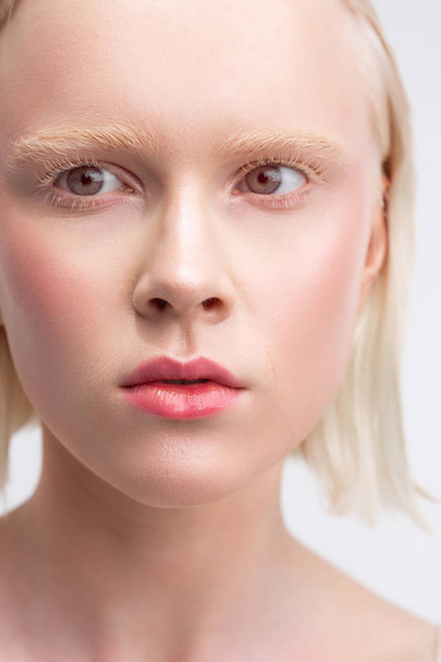 Woman with bob cut having rosy blusher and white eyebrows - Foto, Bild