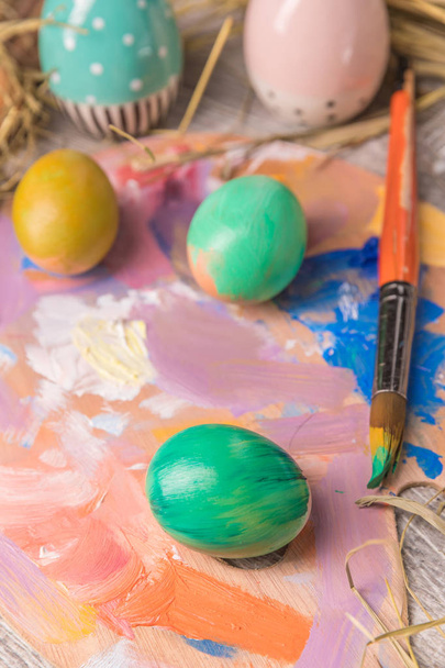 Easter composition with Easter eggs on wooden background - Fotoğraf, Görsel