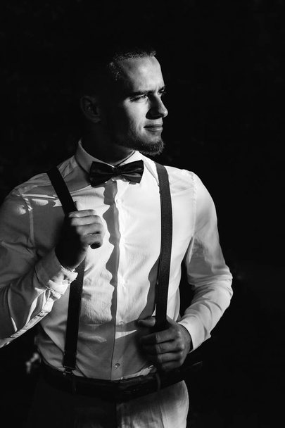 stylish guy in a white shirt with bow tie and suspenders. guy lo - Fotografie, Obrázek