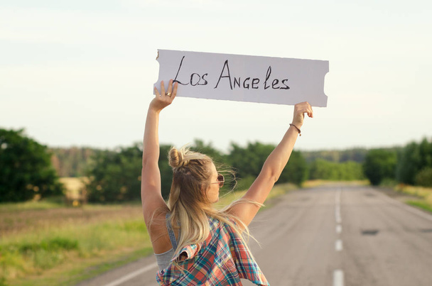 Beautiful Girl Hitchhiking On The Road Traveling. - Photo, Image