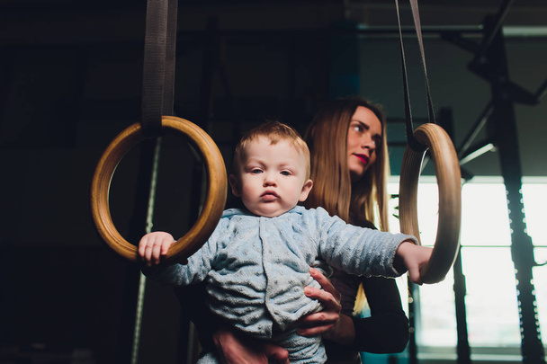 Woman as a therapist at physiotherapy and sports with child in gym. - Photo, Image