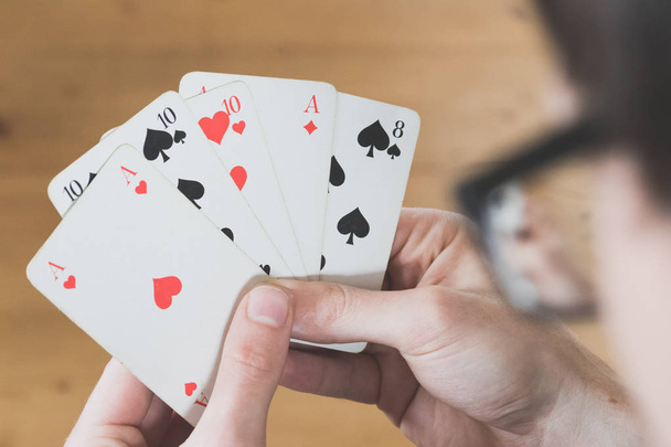 Playing cards: Poker cards in the hand of a man - Photo, Image