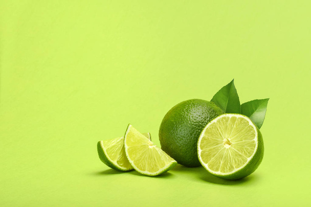 Limes on green background copyspace - Photo, Image