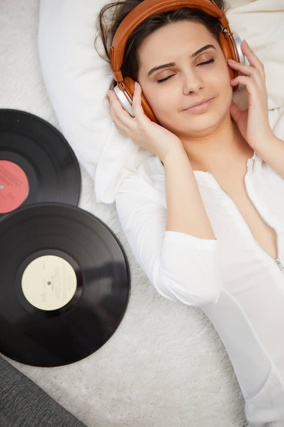 the image of resting sexy woman listening to vinyl - Fotó, kép