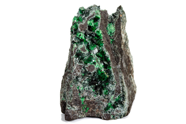 Macro stone garnet mineral, Uvarovite in rock on a white backgro - Photo, Image