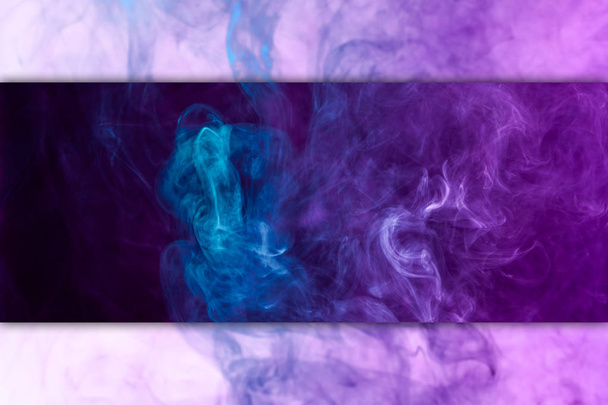 Dense multicolored smoke of   blue and purple colors on a black and white isolated background. Background of smoke vap - Zdjęcie, obraz