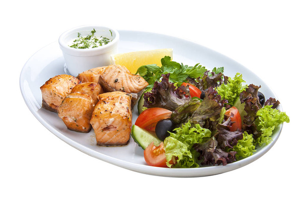 Shish kebab from salmon with vegetables and salad.  - Photo, Image