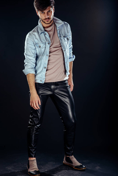 Handsome young elegant man in blue jacket pose against studio background - Fotó, kép