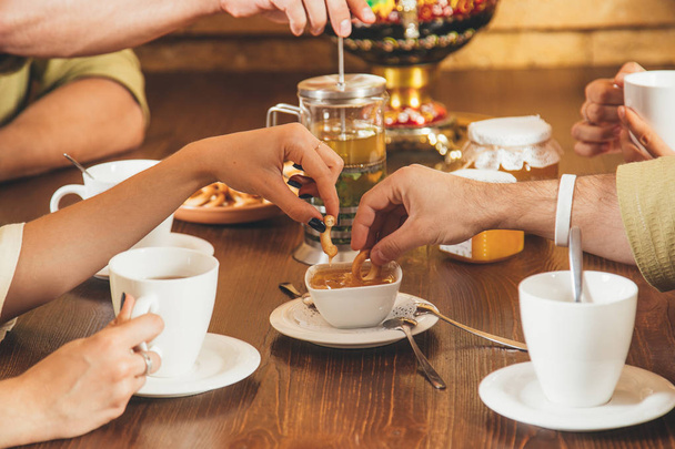 Friends drink herbal tea after spa treatments in the sauna. Concept - healthy lifestyle - 写真・画像