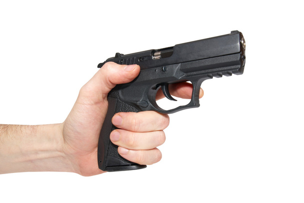Pistola negra en una mano
 - Foto, Imagen