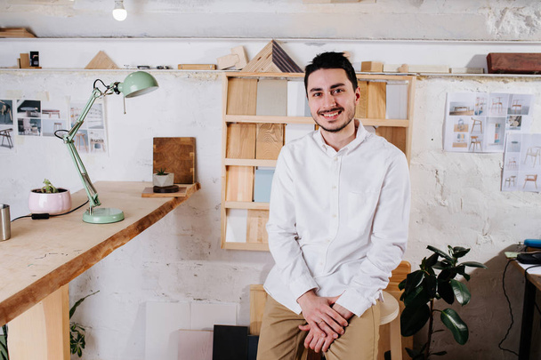 Environmental portrait of a furniture designer maker in his workshop - Fotoğraf, Görsel