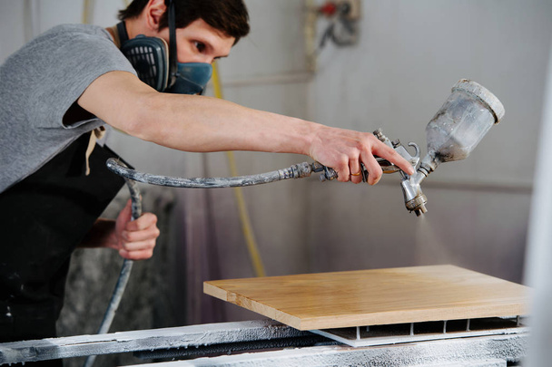 Carpenter is making furniture on order in a workshop. - Foto, afbeelding