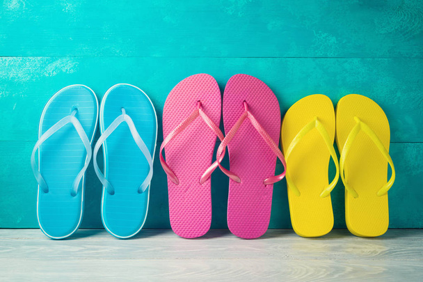 Summer concept background with flip flops on wooden table.  - Zdjęcie, obraz