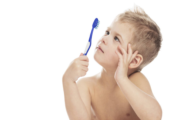 Cute little boy with a toothbrush in his hands. Close-up. Isolat - Photo, Image
