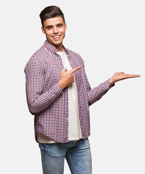 Young cool man holding something with hand - Photo, Image