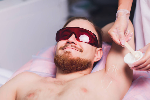 Male depilation laser hair removal procedure treatment. Skin preparation process of preparing, applying gel. - Φωτογραφία, εικόνα