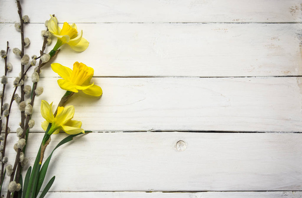 Spring flowers on the wooden background, yellow easter daffodils - Photo, Image