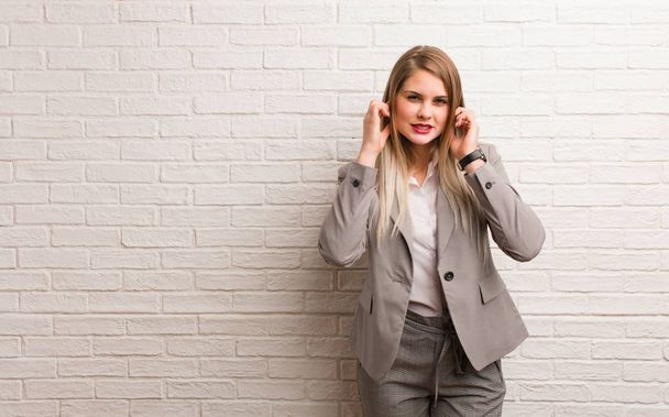 Young russian business woman covering ears with hands - Photo, Image
