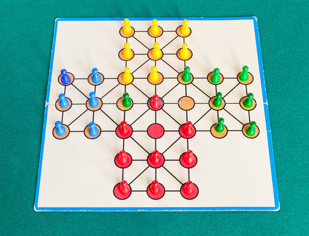 gameplay of solitaire board game on green table - Photo, image