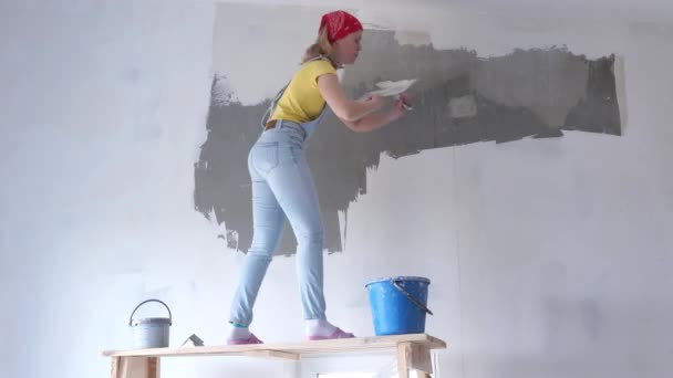Oprava v bytě-mladá žena Evropského vzhledu dělá opravy v domácnosti s časotěsněním - Záběry, video
